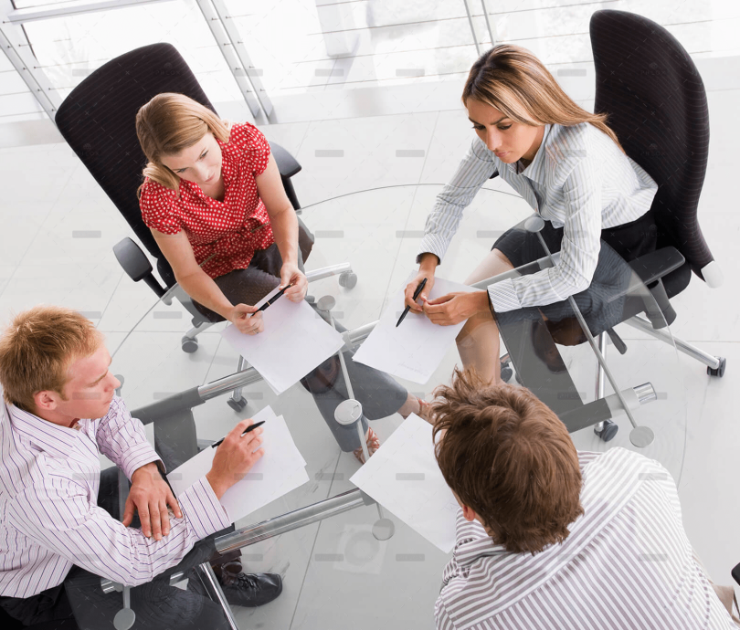demo-attachment-458-four-businesspeople-in-a-boardroom-with-paperwork-PC4V8H4